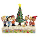 Figurine of Charlie Brown and friends around a Christmas tree with a star on top, on a decorative base.