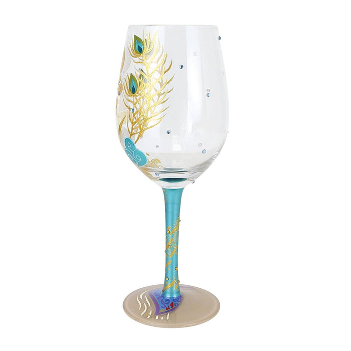 Wine glass with peacock feather design on a white background