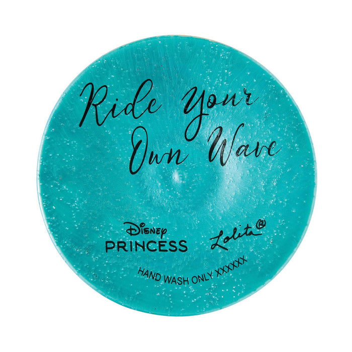 Round turquoise soap with 'Ride Your Own Wave' text and Disney Princess branding on a white background