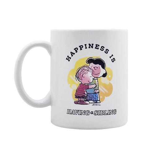 White mug with cartoon design and text 'Happiness is having a sibling' on a white background