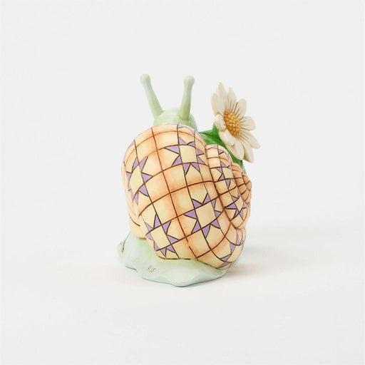 Decorative snail figurine with a geometric shell on a white background