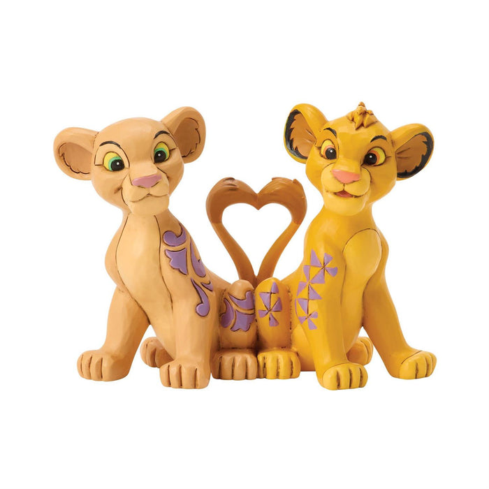 Two lion figurines with a heart-shaped object on a white background