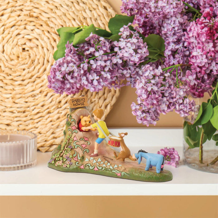 Decorative figurine with characters from 'The Wishing Well' surrounded by purple flowers.