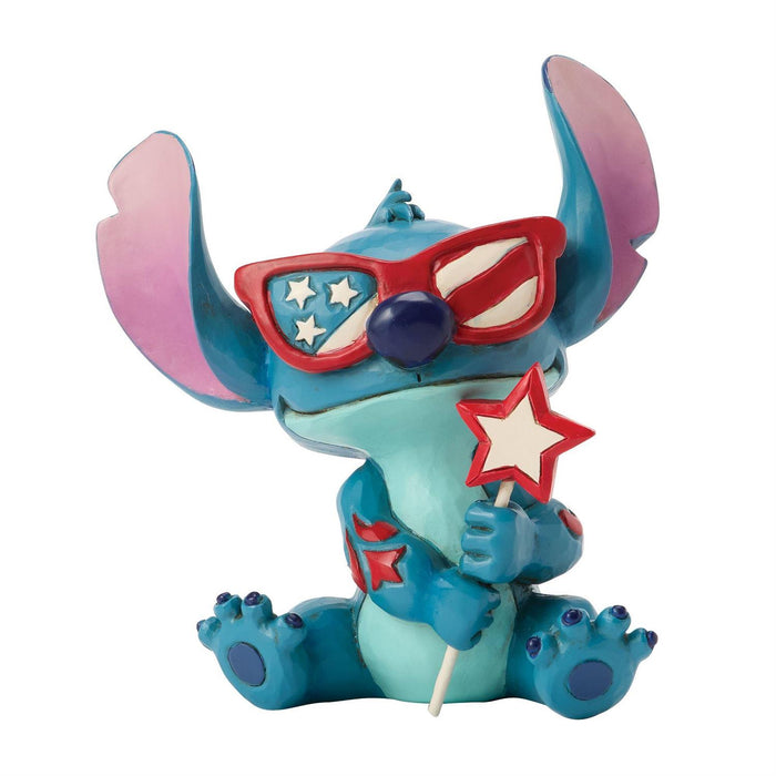 Toy figure of a character wearing sunglasses and holding a lollipop with a star on a white background