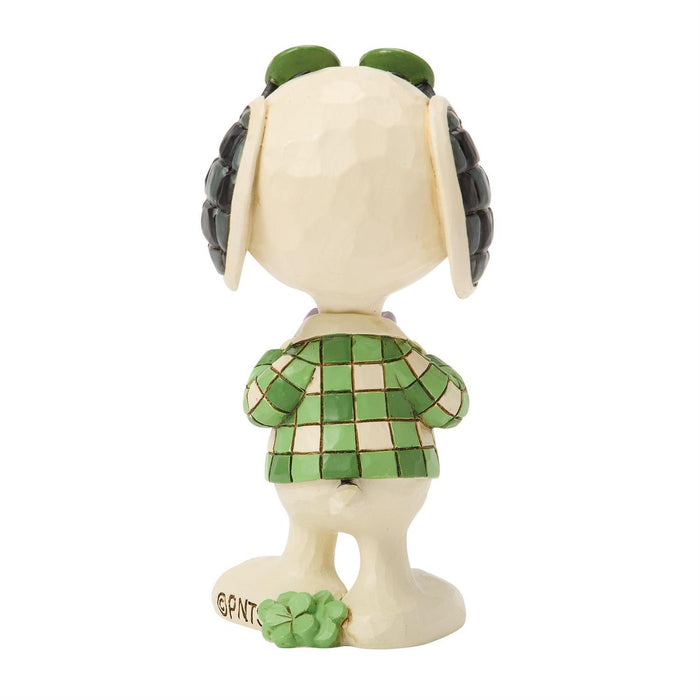 Animated character figurine with green checkered dress on a white background