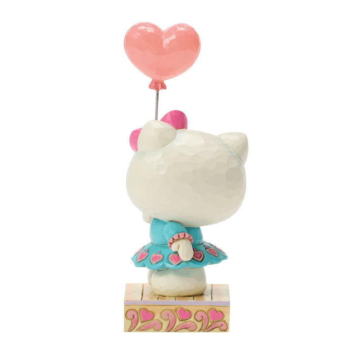 Hello Kitty figurine with a pink heart balloon on a white background