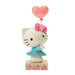 Hello Kitty figurine holding a heart-shaped balloon with 'LOVE' on a white background