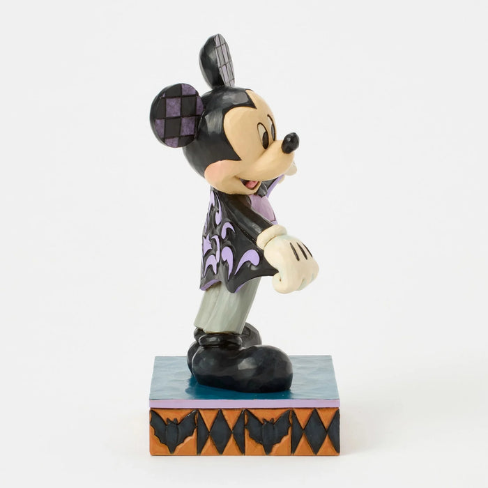 Mickey Mouse figurine in Halloween costume on a white background