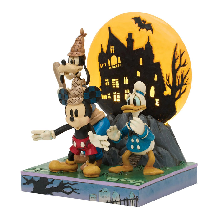 Disney Halloween figurine with Mickey Mouse and Goofy in front of a haunted house silhouette.