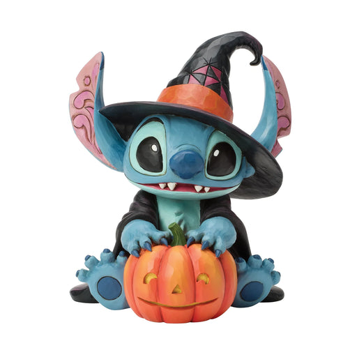 Toy figure of a character in a Halloween costume with a pumpkin on a white background