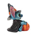 Toy figure of a character in a witch costume with a pumpkin on a white background