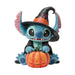 Toy figure of a character in a Halloween costume with a pumpkin on a white background