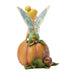Fairy figurine on a pumpkin with a white background