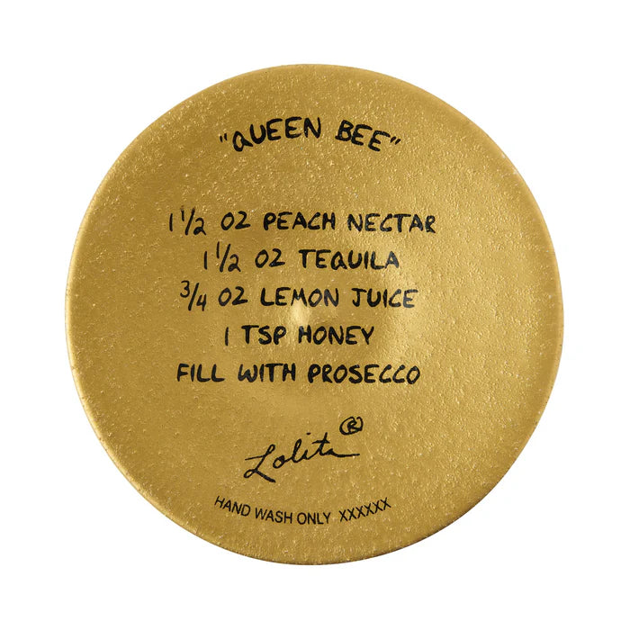 Gold round coaster with drink recipe and brand name on a white background