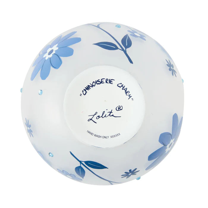 White ceramic bowl with blue floral patterns and 'Lolita' branding on a white background