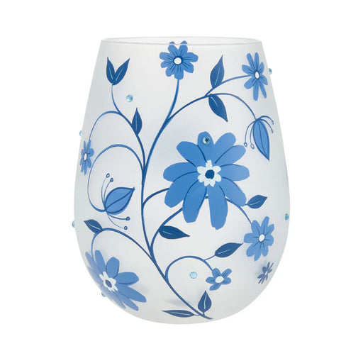White wine glass with blue floral designs on a white background
