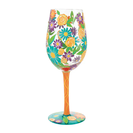Decorative wine glass with floral design on a white background