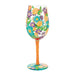Decorative wine glass with floral design on a white background