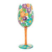 Decorative wine glass with colorful floral design on a white background