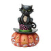 Decorative figurine of a black cat on a top hat with a pumpkin base on a white background