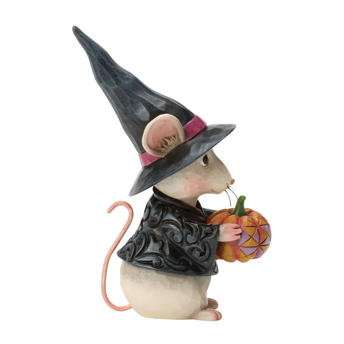 Halloween-themed mouse figurine wearing a witch hat and holding a pumpkin on a white background