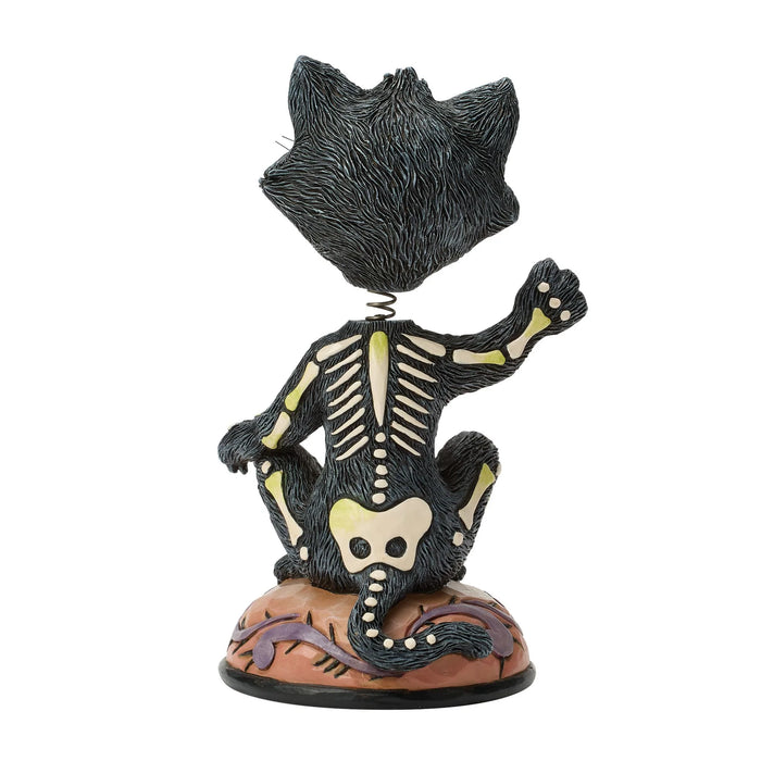 Cat skeleton figurine on a white background