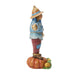 Statue of a character in a blue outfit and straw hat standing on a pumpkin with a white background