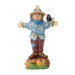 Decorative scarecrow figurine with a bird on a white background
