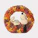 Snoopy figurine inside a wreath made of autumn leaves on a white background