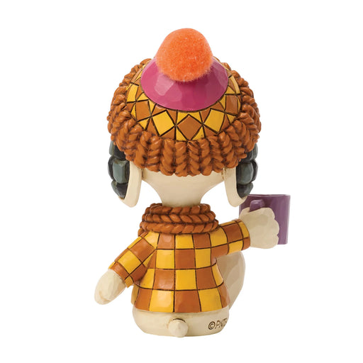 Colorful figurine with a checkered outfit and hat on a white background