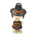 Toy figure of a character wearing a witch hat and dress on a white background