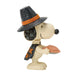 Snoopy figurine wearing a Halloween witch hat on a white background