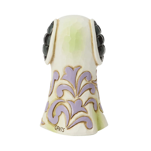 Decorative ceramic dog figurine with intricate designs on a white background