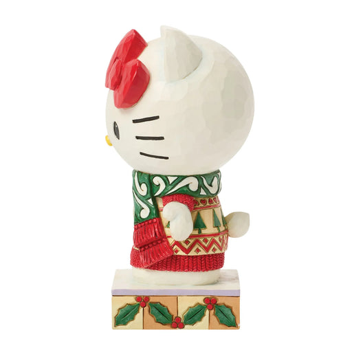 Hello Kitty figurine wearing a Christmas sweater on a white background