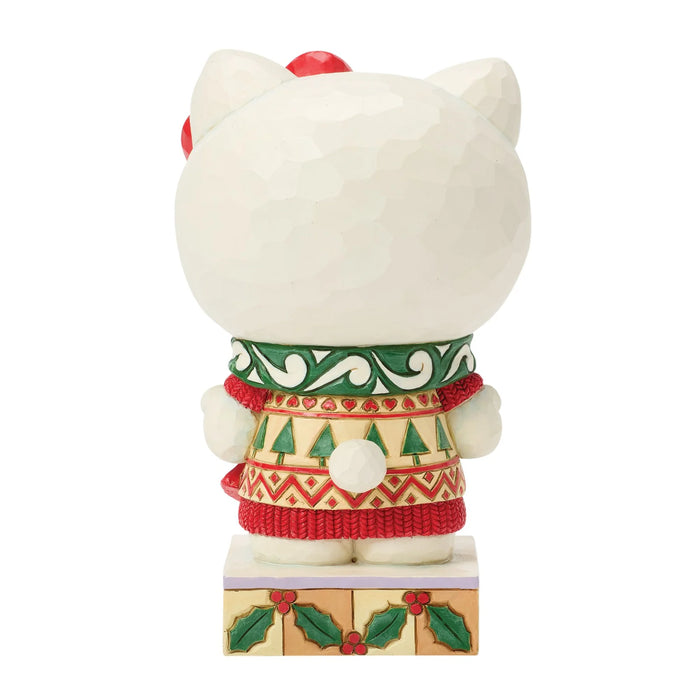 A Hello Kitty collectible figurine shown from the back, wearing a festive Christmas sweater and standing on a decorated base against a plain white background.