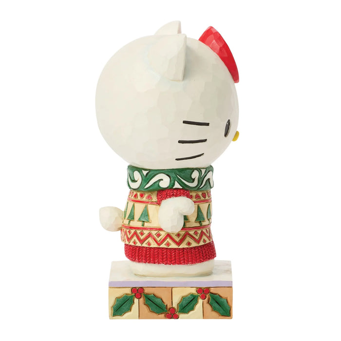 Hello Kitty figurine wearing a Christmas sweater on a white background