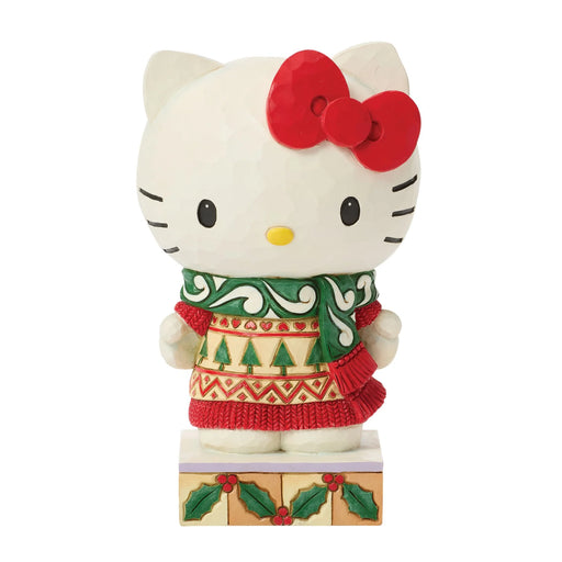 Hello Kitty figurine wearing a Christmas sweater on a white background