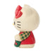 Hello Kitty figurine wearing a Christmas sweater and holding a stocking on a white background