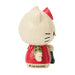 Hello Kitty figurine wearing a Christmas sweater and holding a stocking on a white background