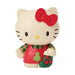 Hello Kitty figurine wearing a Christmas sweater and holding a stocking on a white background
