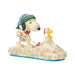 Decorative figurine of Snoopy and Woodstock shoveling snow with festive hats on a white background
