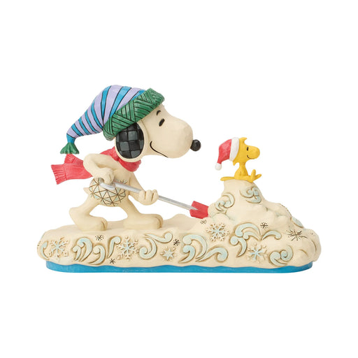 Snoopy figurine with a hat and scarf on a white background