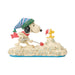 Snoopy figurine with a hat and scarf on a white background