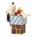 Snoopy figurine with Woodstock on a colorful box against a white background