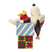 Figurine of a character from Peanuts series hugging a gift box with a white background