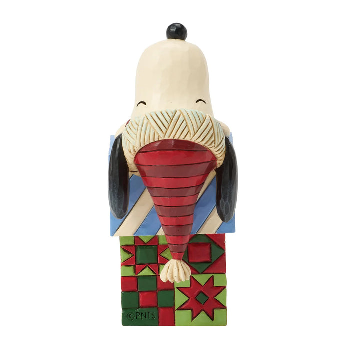 Snoopy figurine with a colorful geometric pattern on a white background