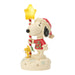 Snoopy figurine holding a candy cane and star on a white background