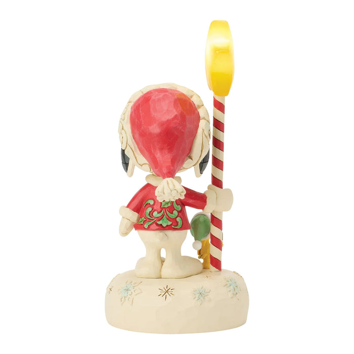 Animated character figurine holding a candy cane on a white background