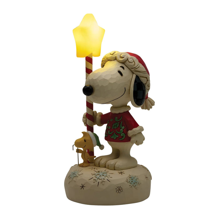 Snoopy figurine holding a star-shaped lamp on a white background