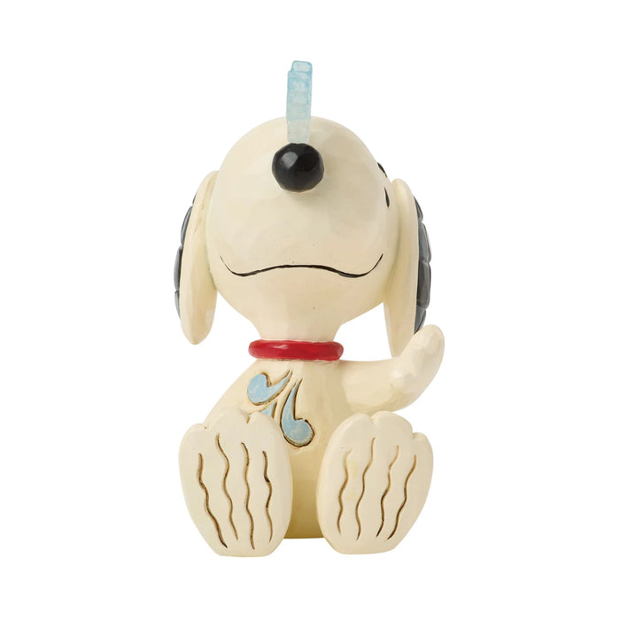 Snoopy figure with a red collar on a white background